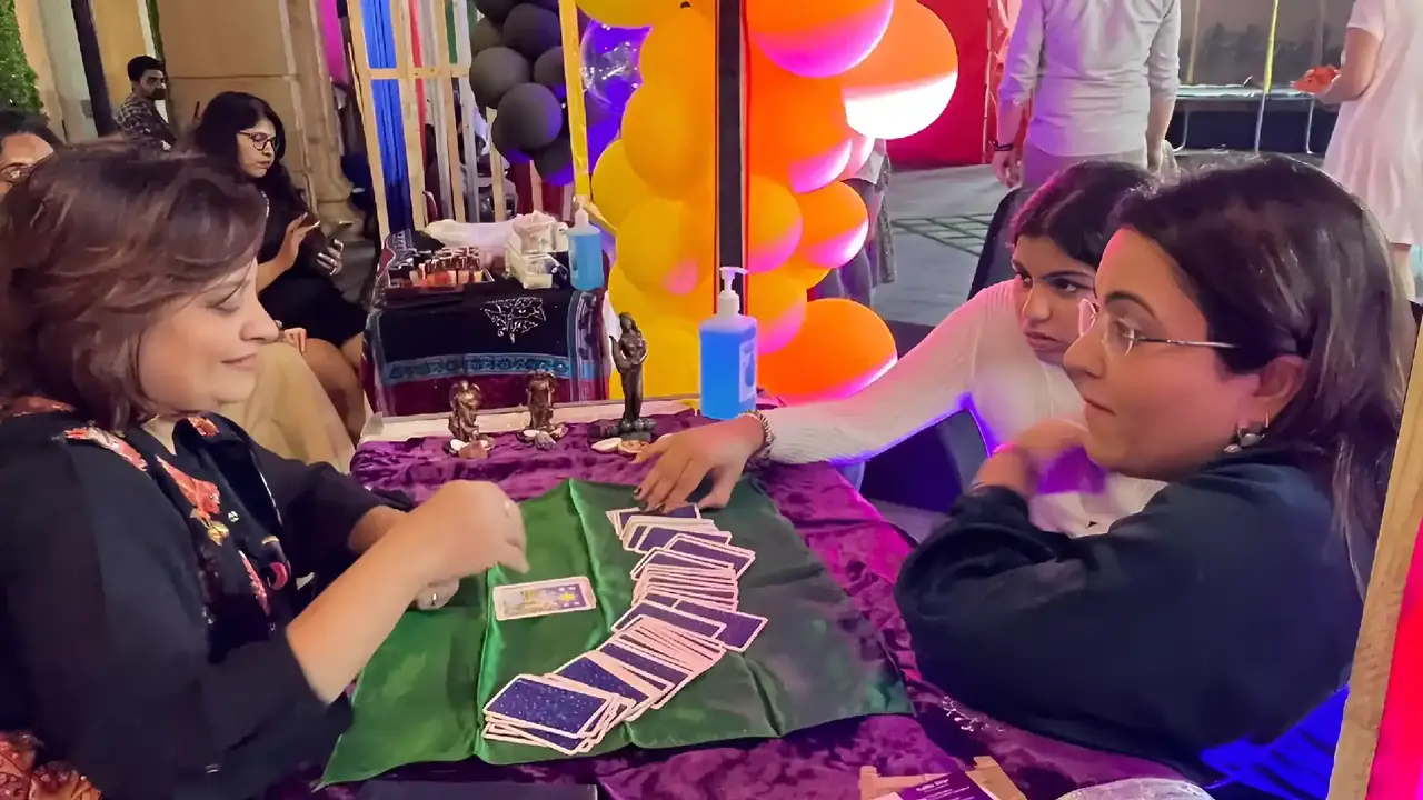 Dr. Riddhe Sshilpi giving a tarot card reading at an event