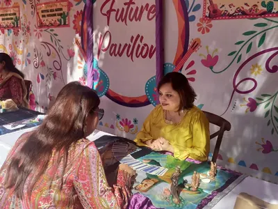 Dr. Riddhe Sshilpi giving a tarot reading at the Future Pavilion event