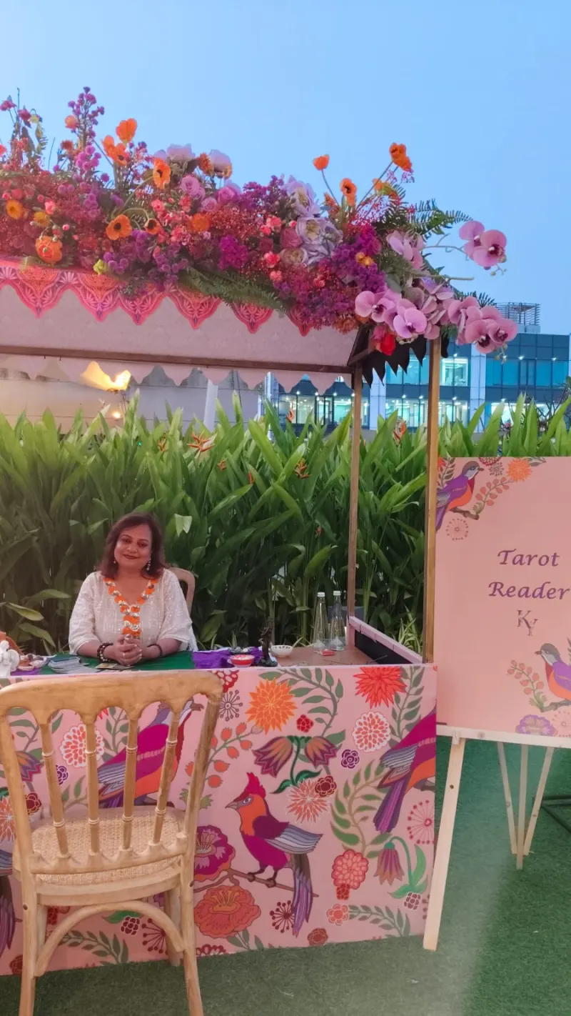 Tarot reading booth with floral canopy at the Jio World Drive event