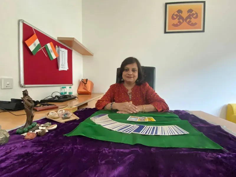 Dr. Riddhe Sshilpi at the tarot reading table set up in an office
