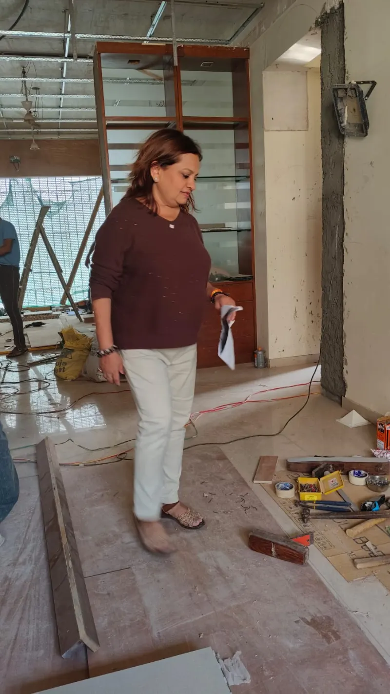 Dr. Riddhe Sshilpi reviewing the living area during Vastu remedies installation