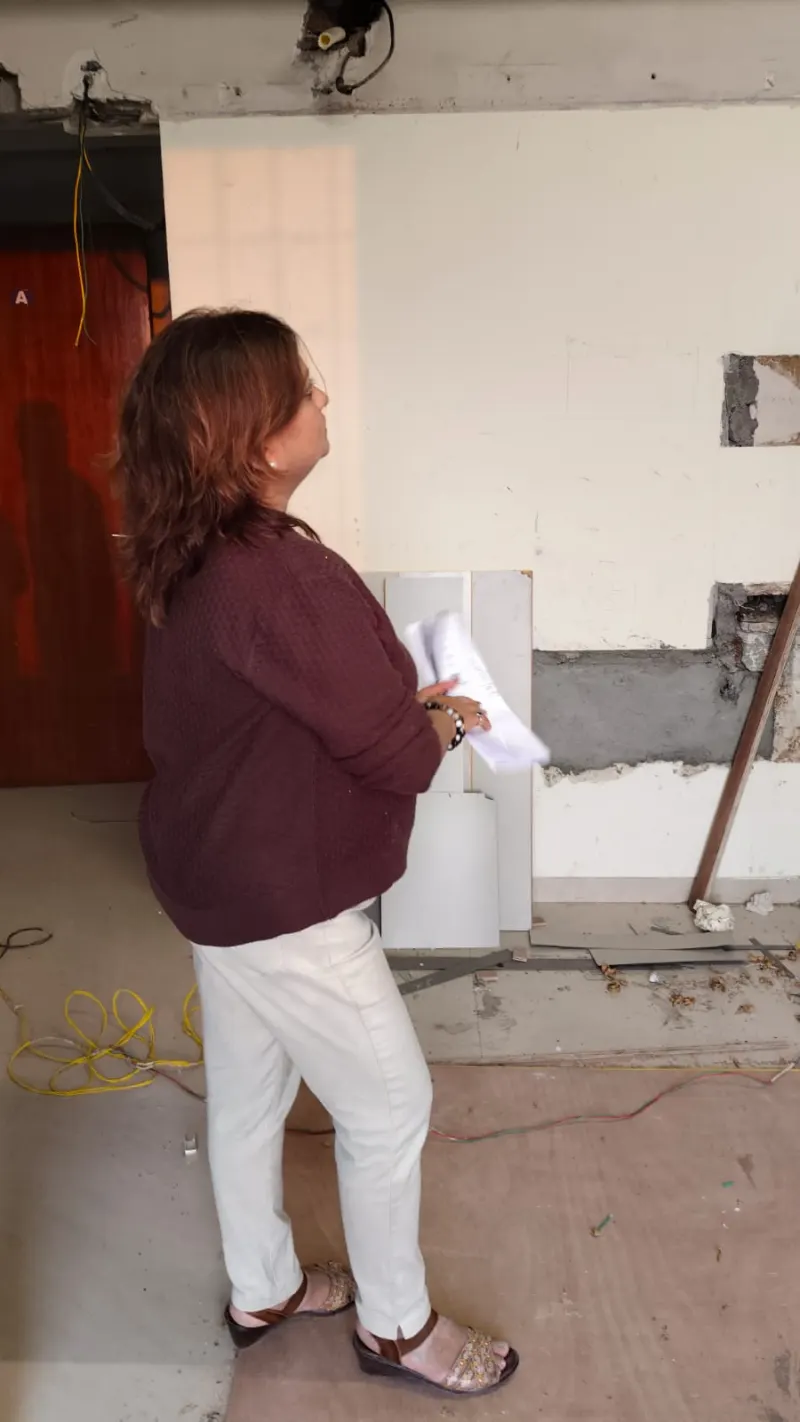 Dr. Riddhe Sshilpi with the Vastu plan in a room under renovation in South Mumbai