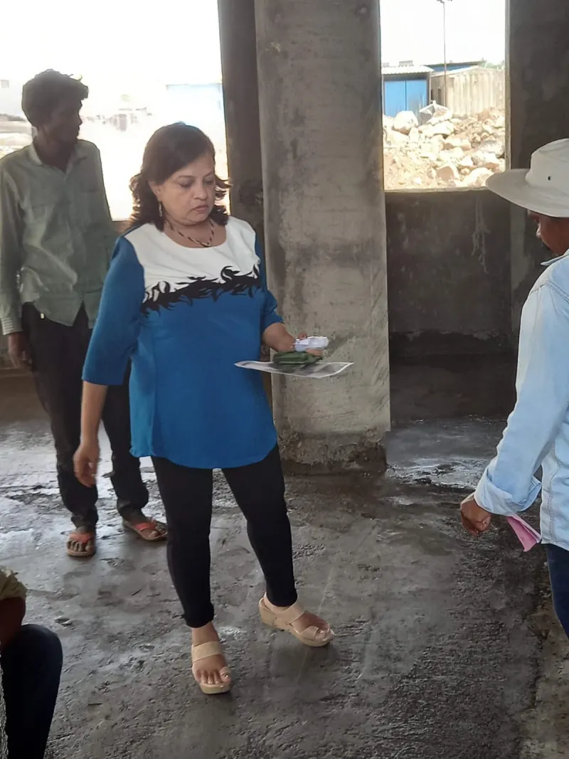 Dr. Riddhe Sshilpi with the drawings among the construction team in Lonavala