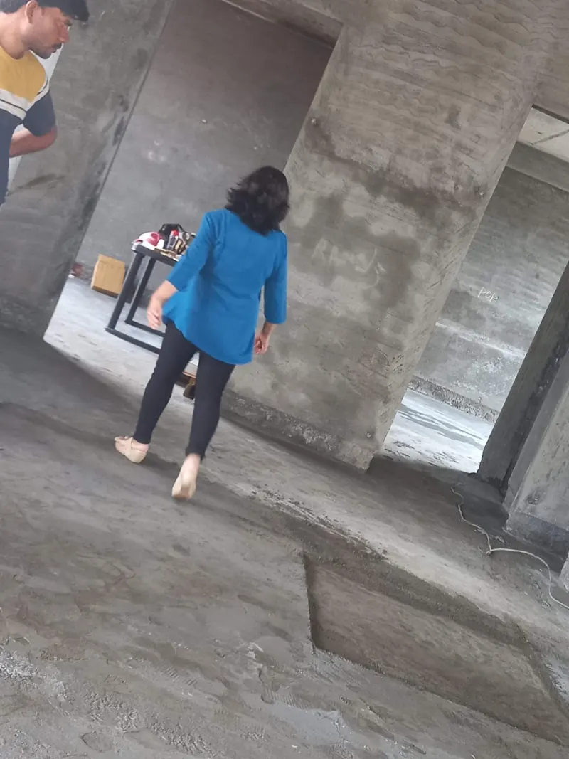 Walking through the under-construction structure during a Vastu site visit