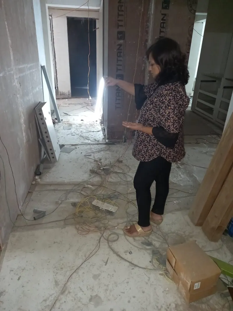 Taking a compass reading inside the Versova property during fit-out