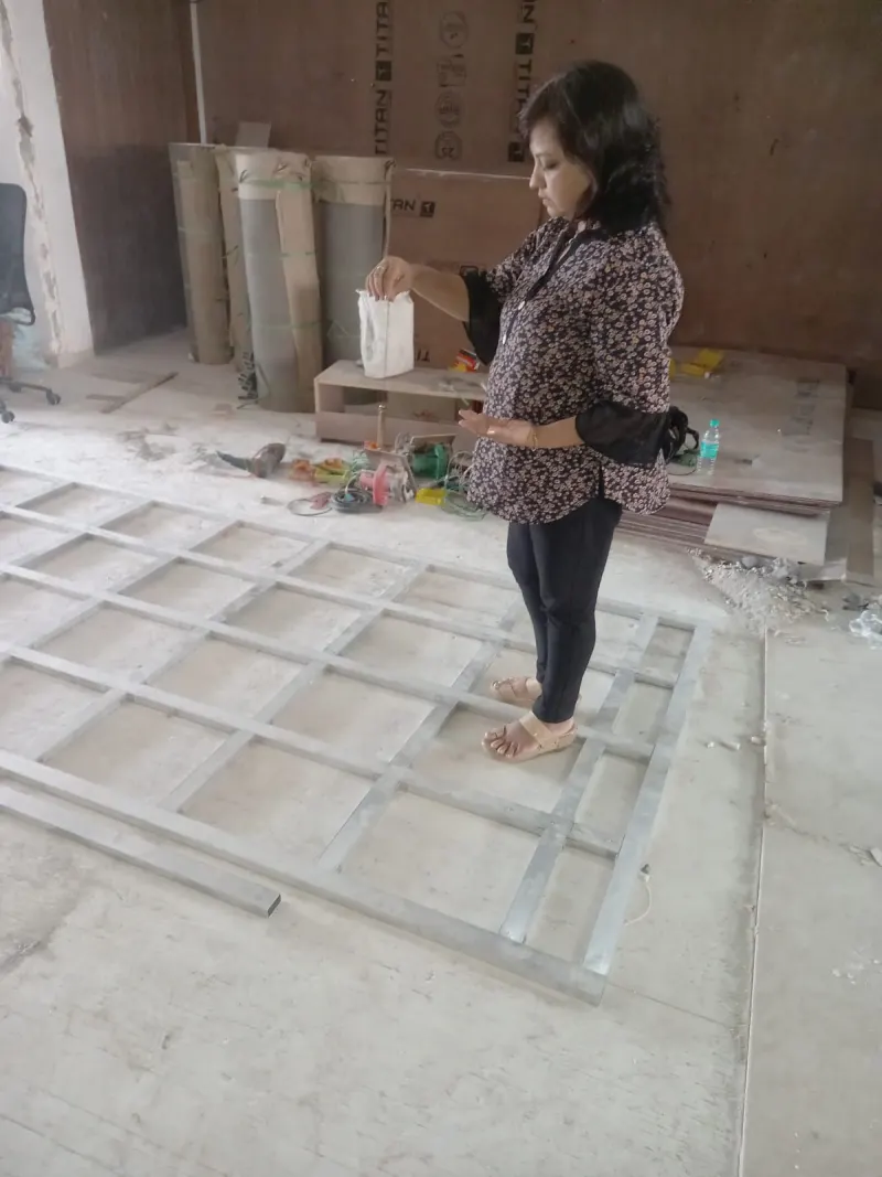Compass reading in an open area of the Versova site during a Vastu consultation